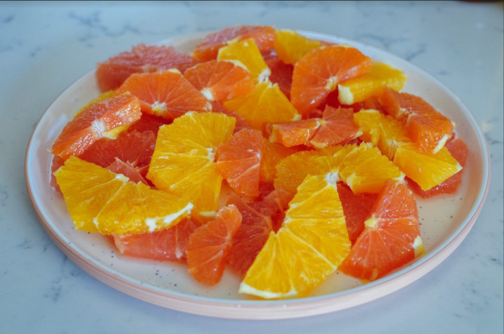 pistachio and honey citrus salad recipe: sliced citrus fruits on plate