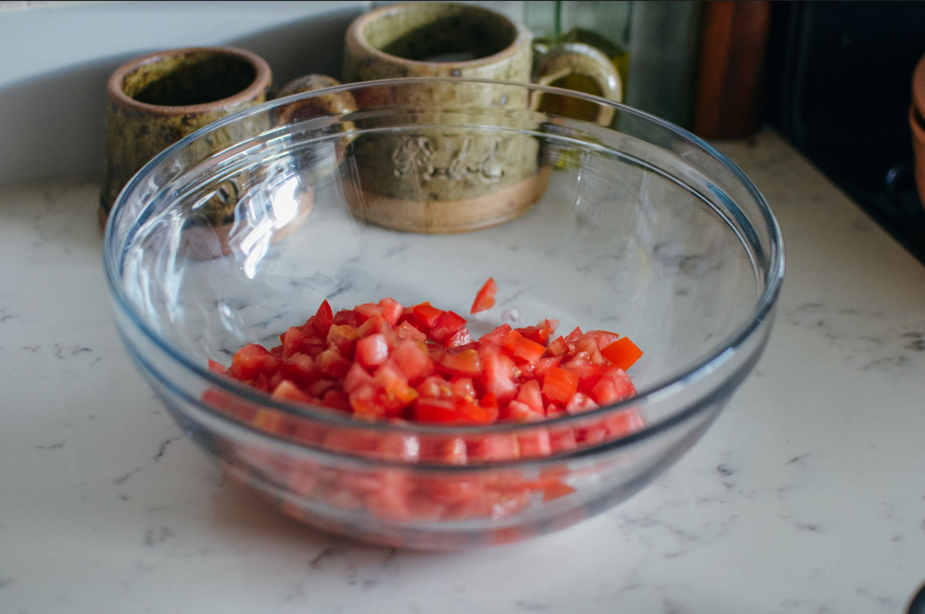 Simple Southern Cracker Salad Recipe- diced tomatoes in glass mixing bowl