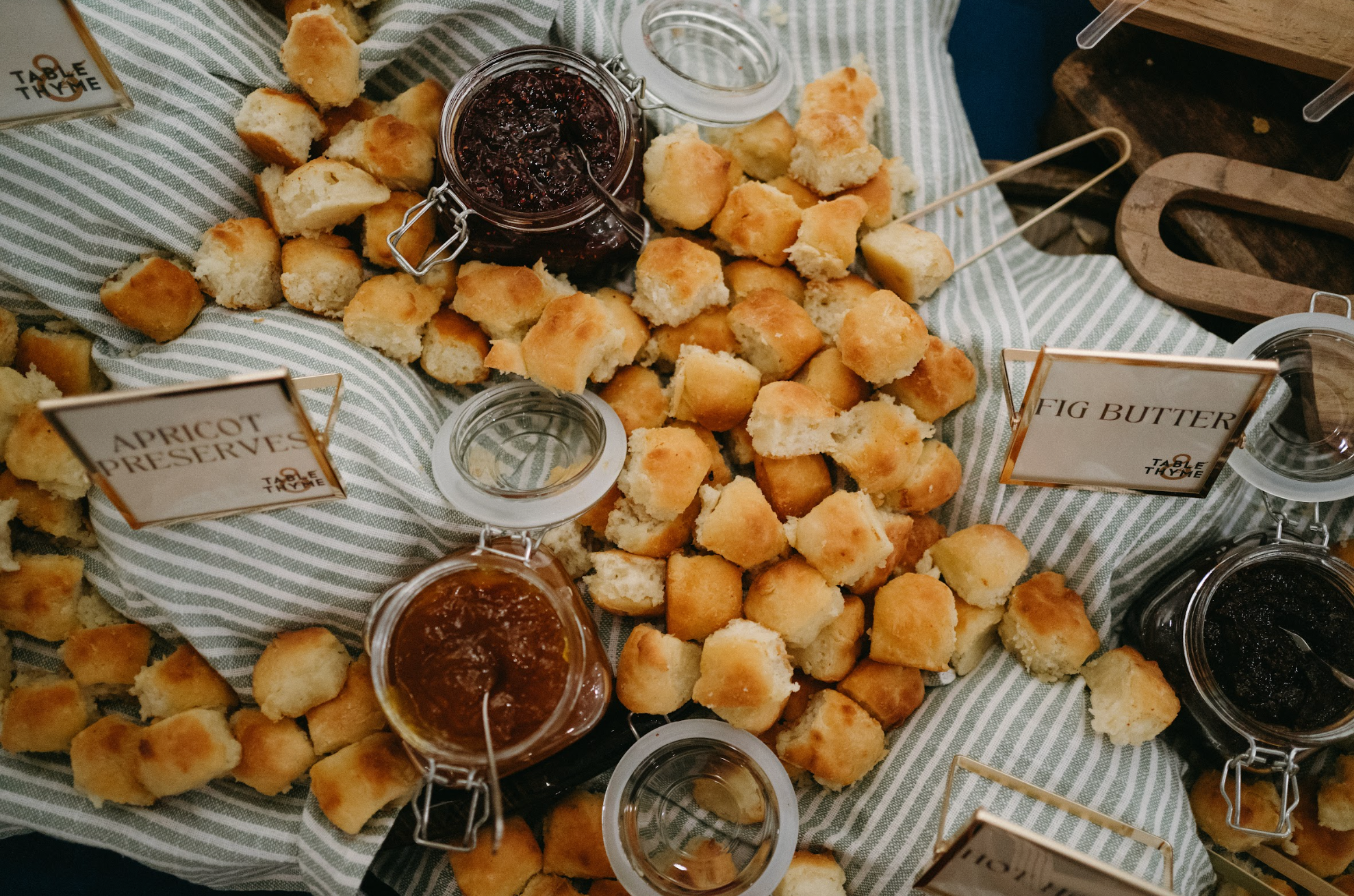 Image of biscuit board: scattered biscuits on table with assorted spreads