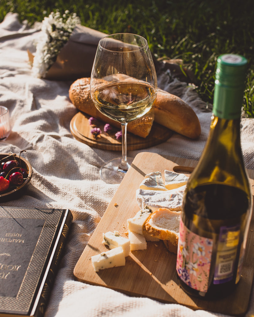 Pair Wine Like a Pro with Table & Thyme. Wine and assorted cheese on picnic blanket
