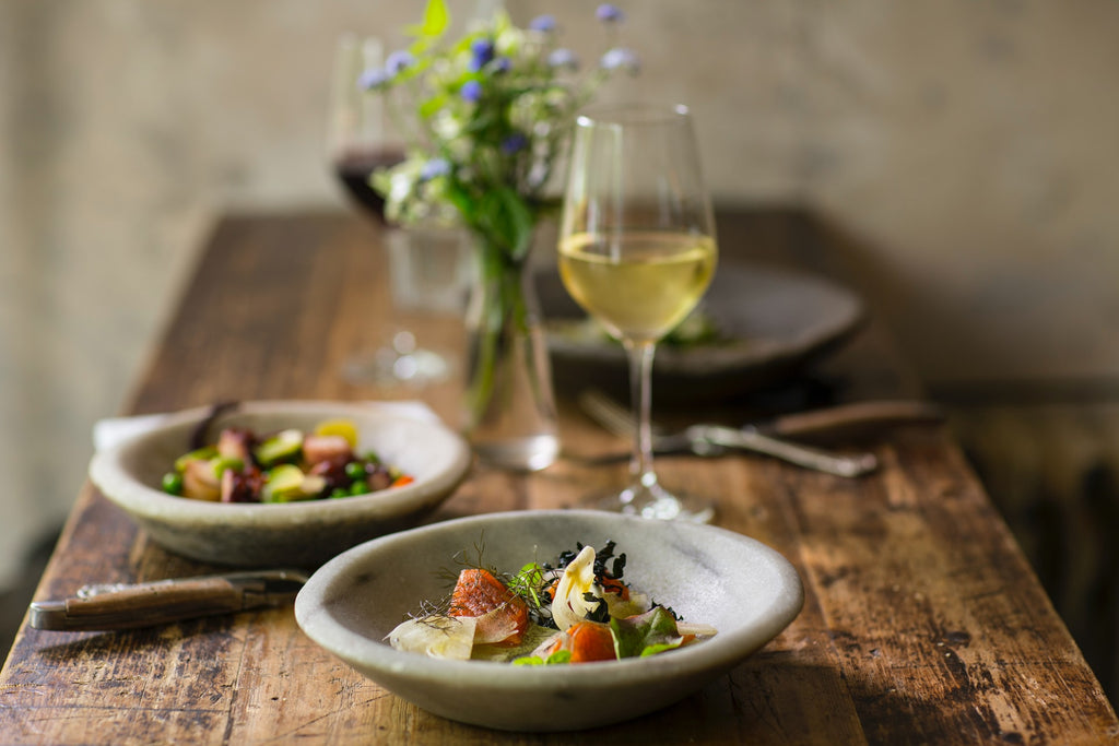 Pair Wine Like a Pro with Table & Thyme. Two bowls of salad with a glass of wine