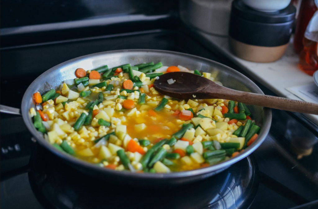 simmering vegetables on stovetop with roux