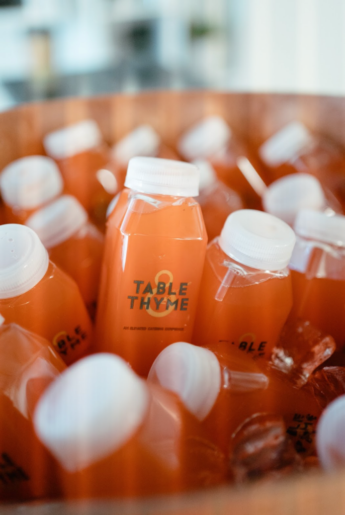 bottles of strawberry lemonade with Table & Thyme branding