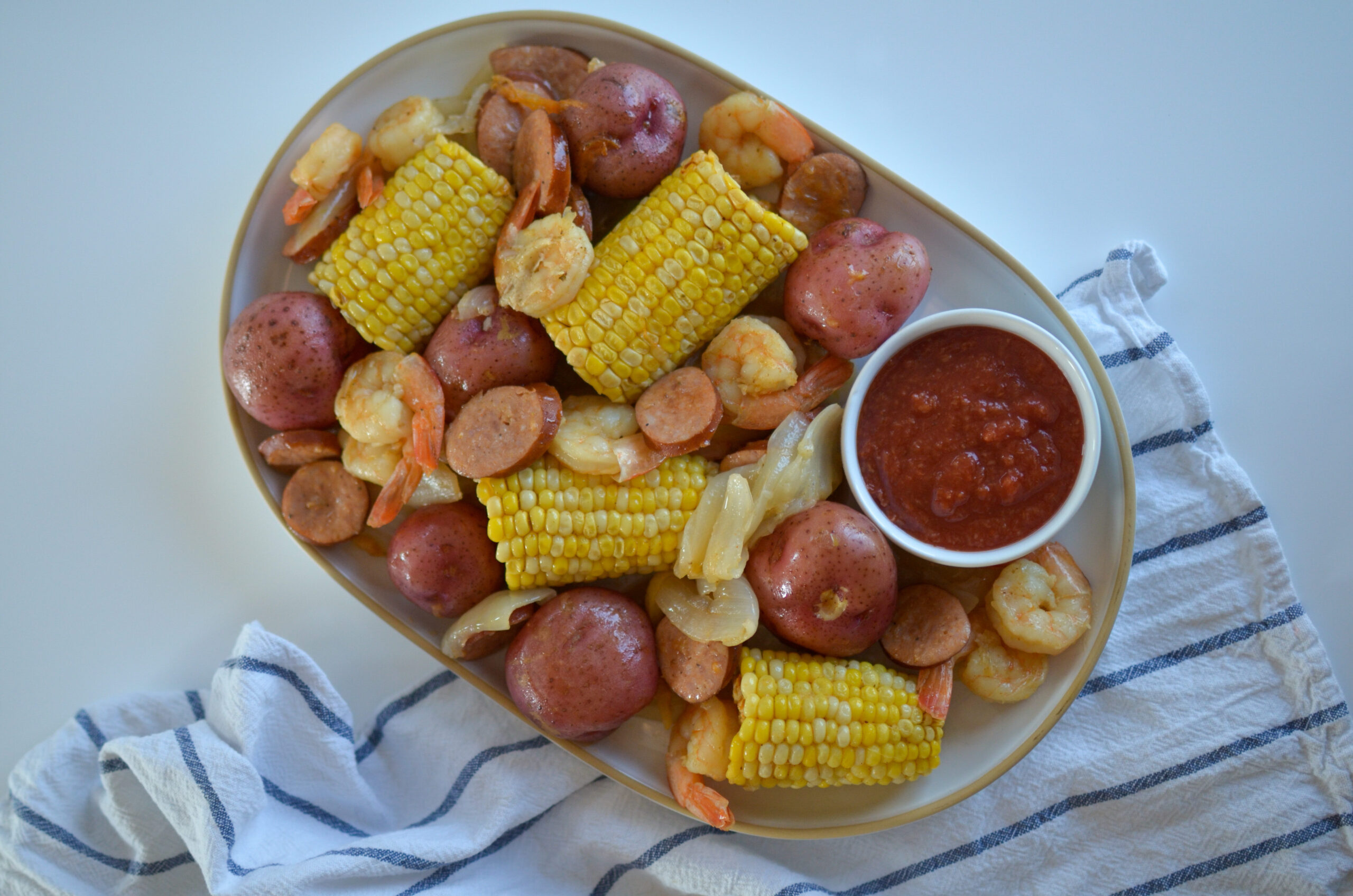 Whether you’re on the coast or spending an evening at home, there’s something about the summer breeze that beckons a low-country boil.